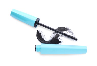 Applicator, mascara for eyelashes and black smear on white background, top view