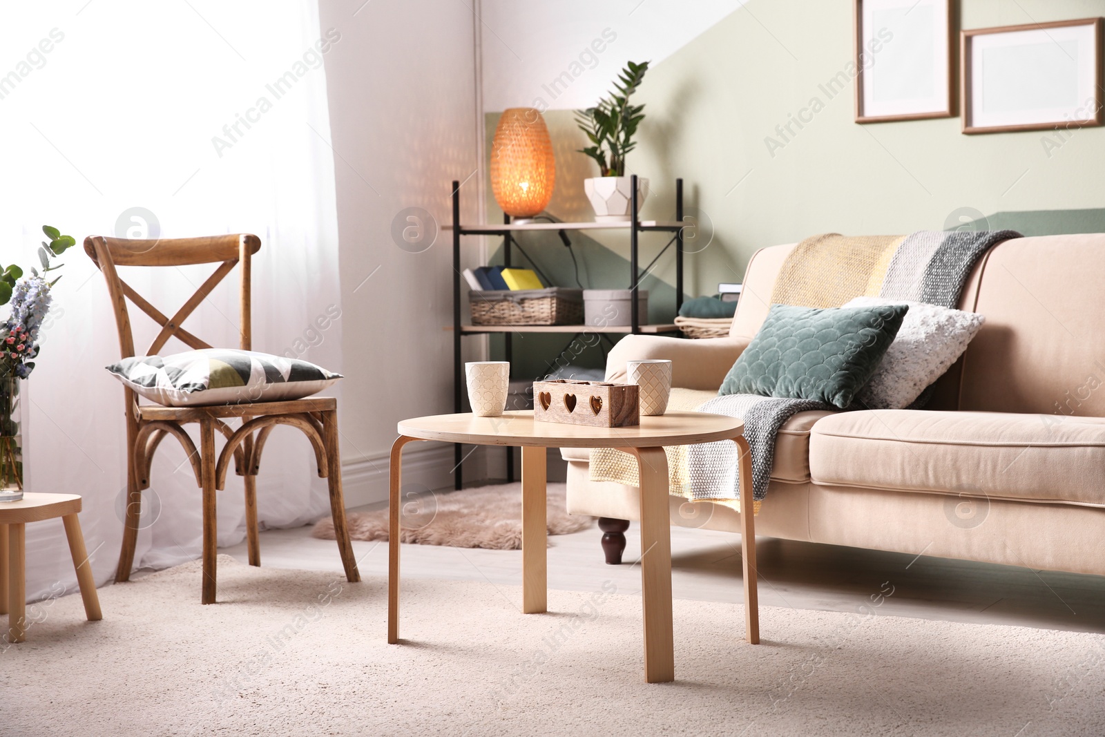 Photo of Stylish living room interior with comfortable sofa and small table