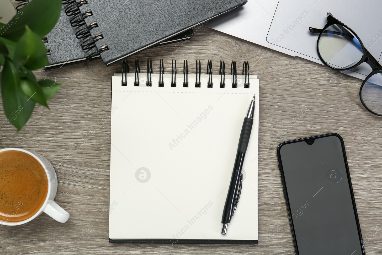 Flat lay composition with notebooks, laptop and smartphone on wooden table Photo of Flat lay composition with notebooks, laptop and smartphone on wooden table