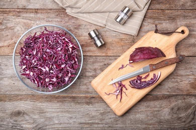 Photo of Flat lay composition with chopped purple cabbage on wooden background