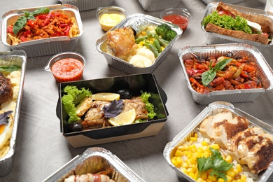 Photo of Lunchboxes on grey table. Healthy food delivery