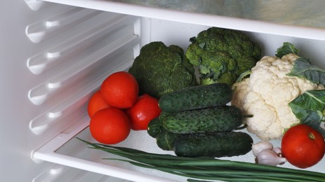 Photo of Many different fresh vegetables on refrigerator shelf