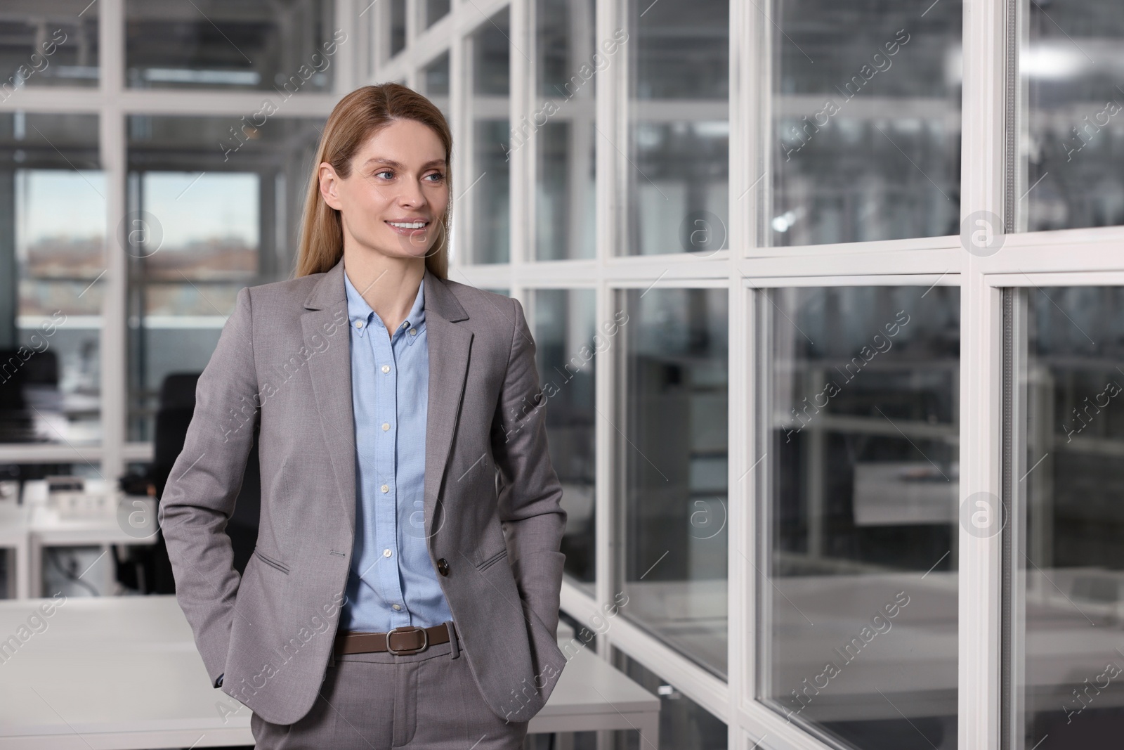 Photo of Female real estate agent indoors. Space for text