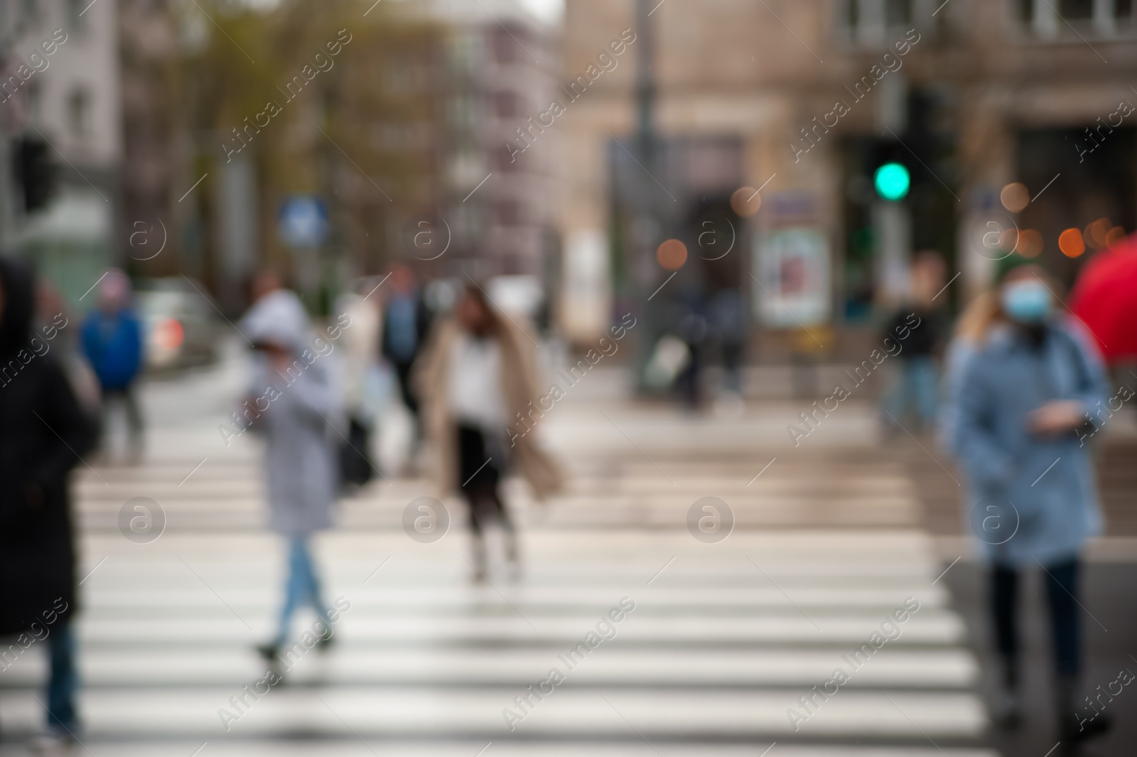 Photo of People at pedestrian crossing outdoors, blurred view