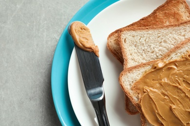 Photo of Toast bread with peanut butter on plate, closeup