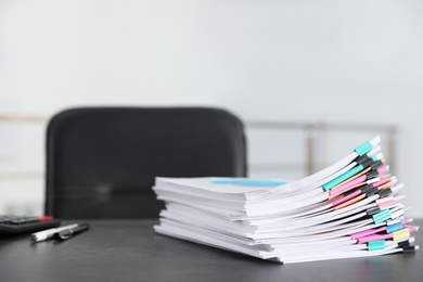 Stack of documents with paper clips on office table. Space for text