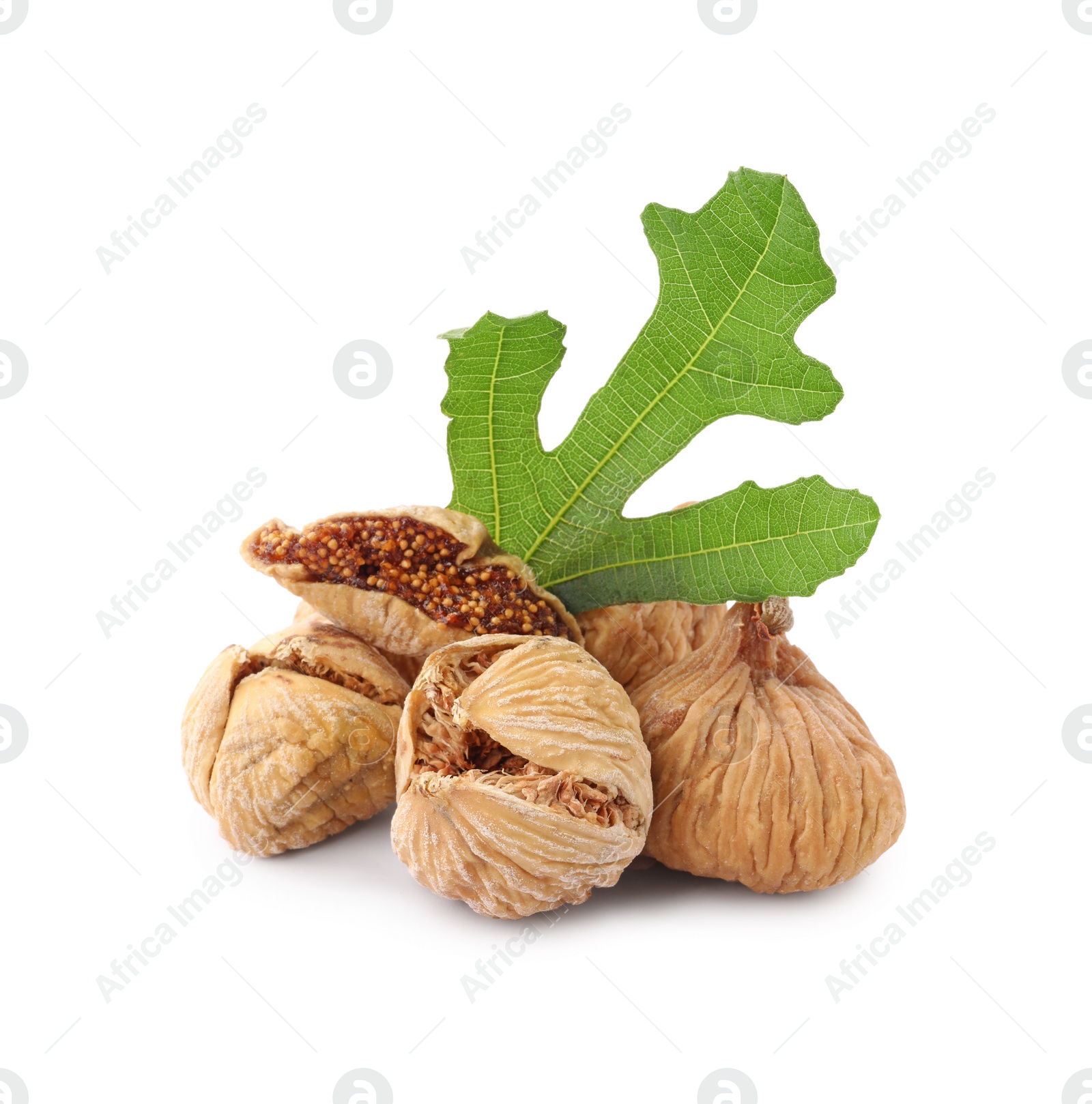 Photo of Tasty dried figs and green leaf isolated on white