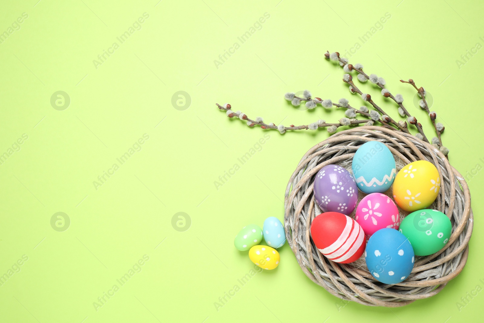 Photo of Flat lay composition with Easter eggs on green background. Space for text