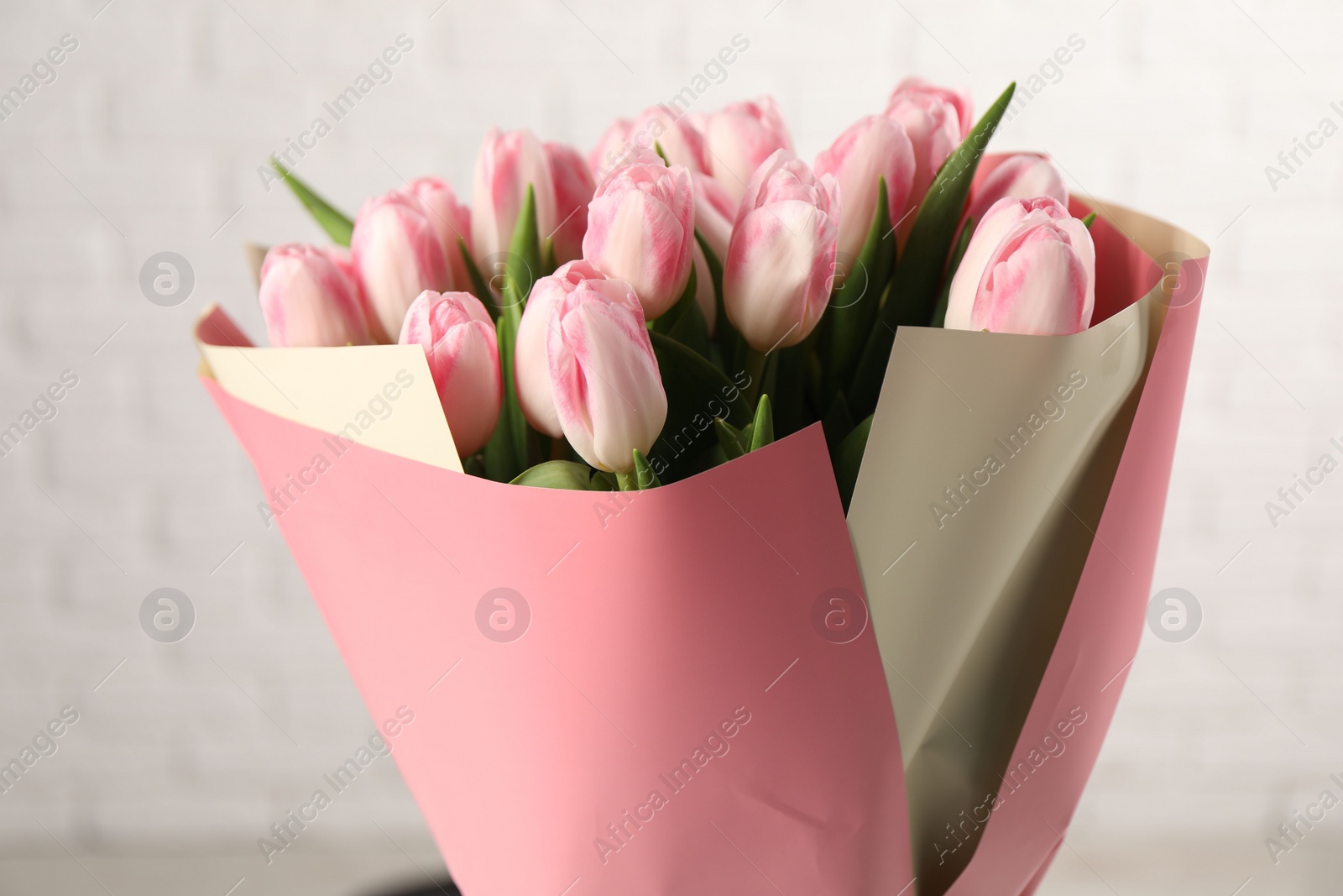 Photo of Beautiful bouquet of fresh pink tulips on blurred background, closeup