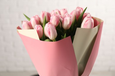 Beautiful bouquet of fresh pink tulips on blurred background, closeup