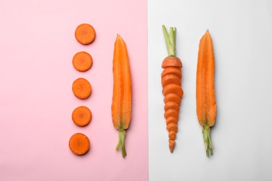 Flat lay composition with fresh sliced carrots on color background