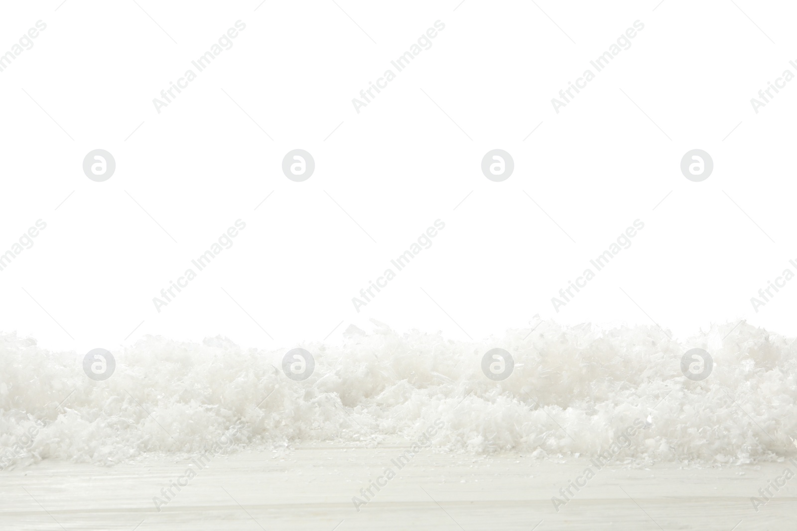 Photo of Snow on wooden surface against white background. Christmas season