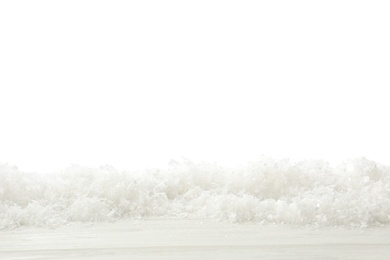 Snow on wooden surface against white background. Christmas season