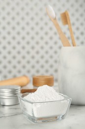 Photo of Tooth powder on white marble table, space for text