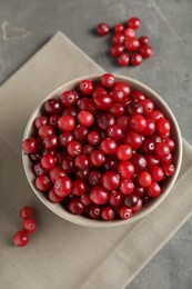 Photo of Cranberries in bowl on light grey table, top view