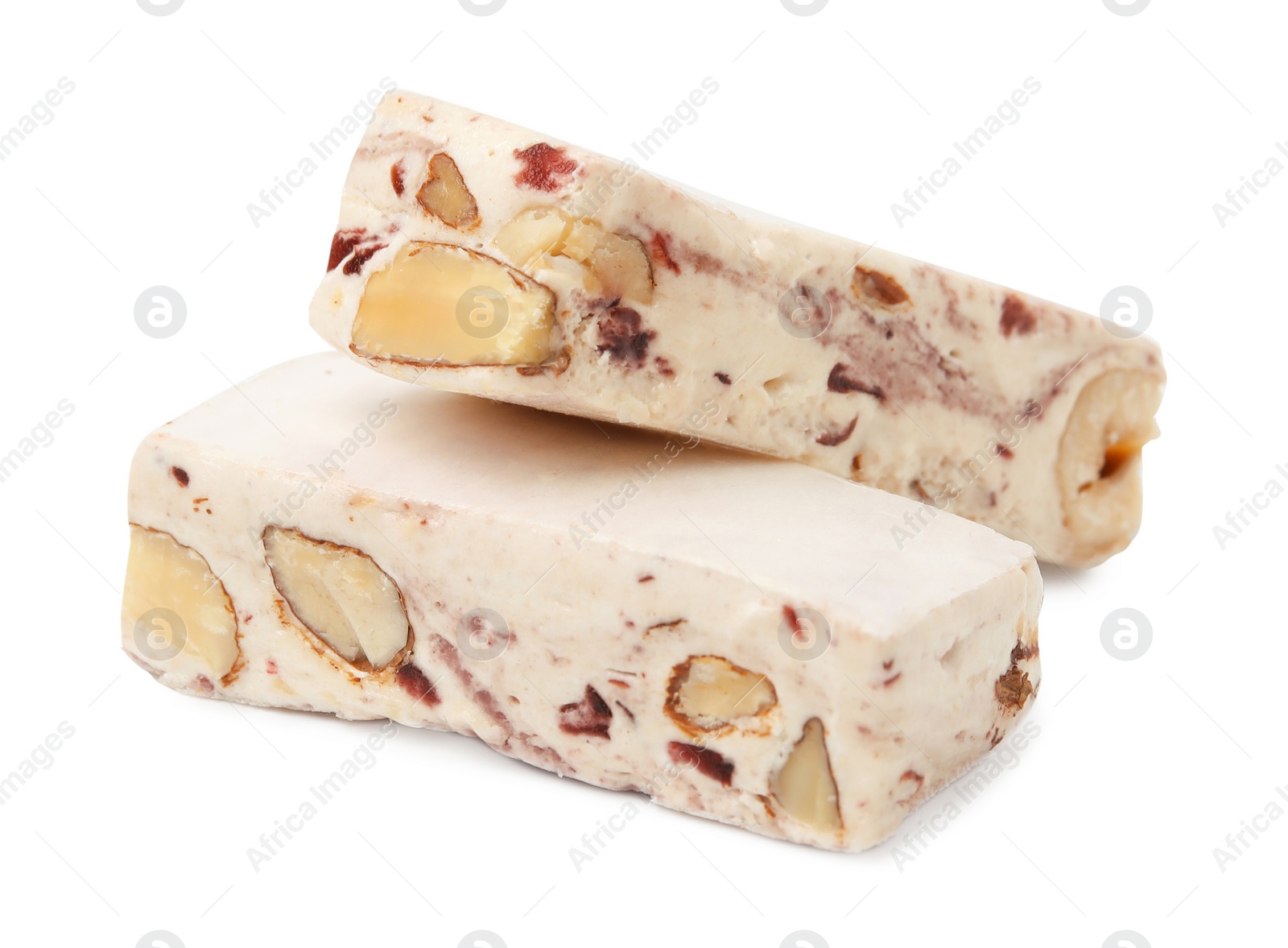 Photo of Pieces of delicious nougat on white background