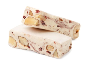 Photo of Pieces of delicious nougat on white background