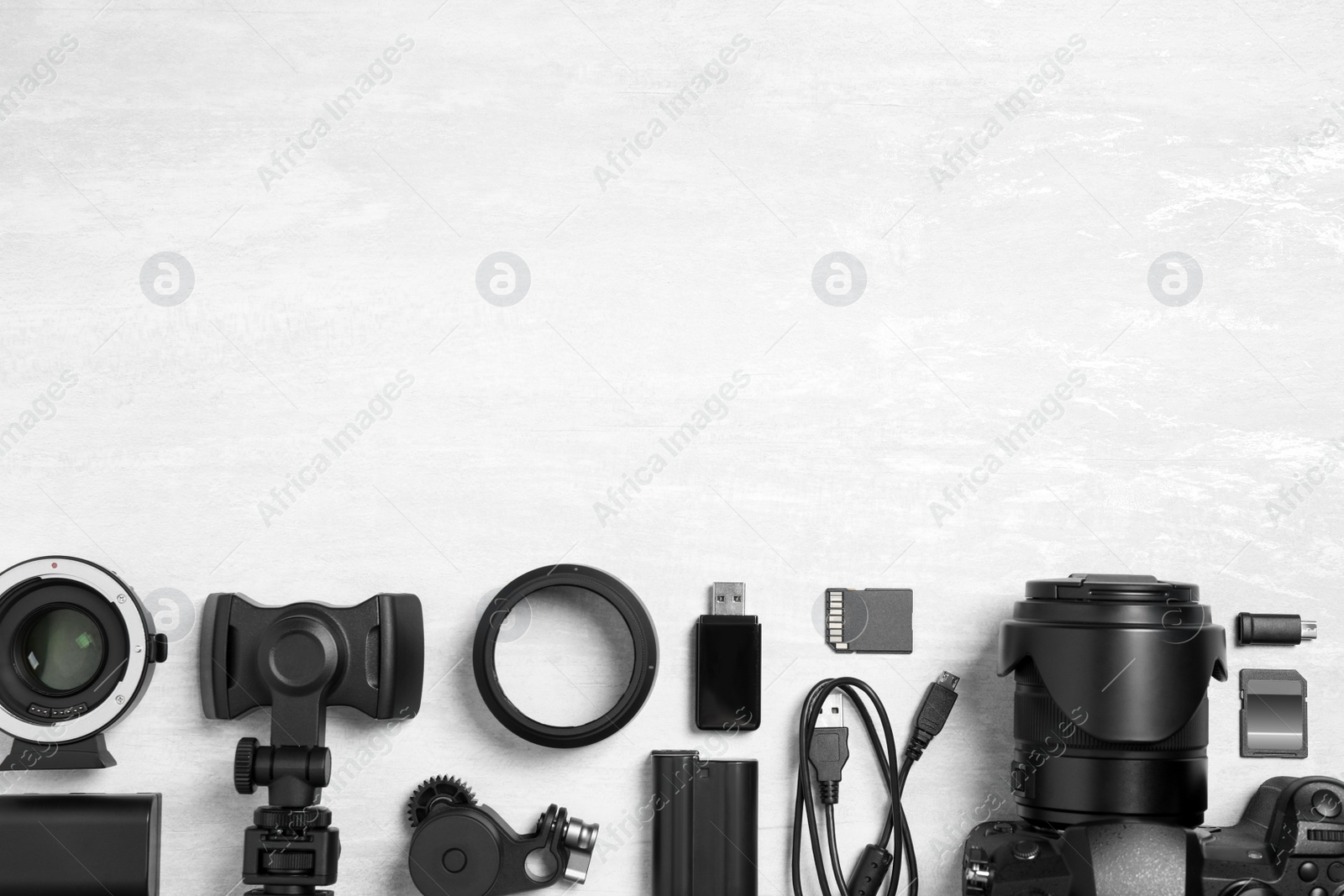 Photo of Camera and video production equipment on light background, flat lay. Space for text