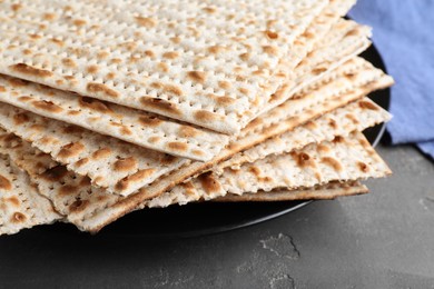 Photo of Stack of matzos on grey table, closeup