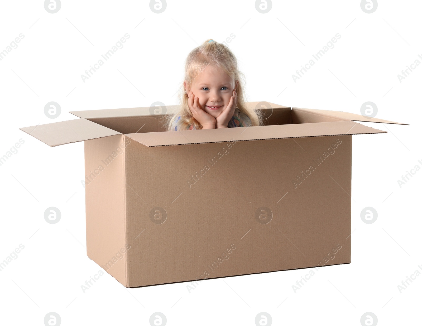 Photo of Cute little girl playing with cardboard box on white background