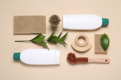 Photo of Flat lay composition with different cleaning supplies on beige background