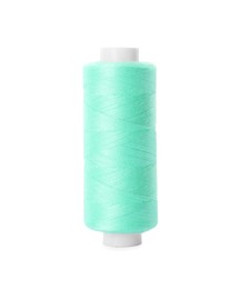 Photo of Spool of turquoise sewing thread isolated on white