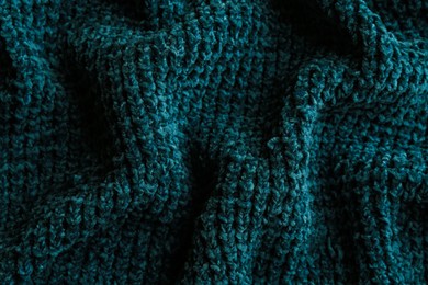 Beautiful dark knitted fabric as background, top view