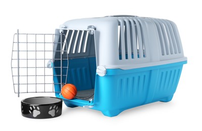 Photo of Light blue pet carrier with toy and bowl isolated on white