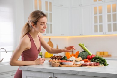 Woman with healthy food in kitchen. Keto diet