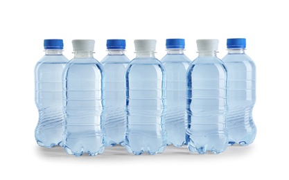 Set of different plastic bottles with water on white background