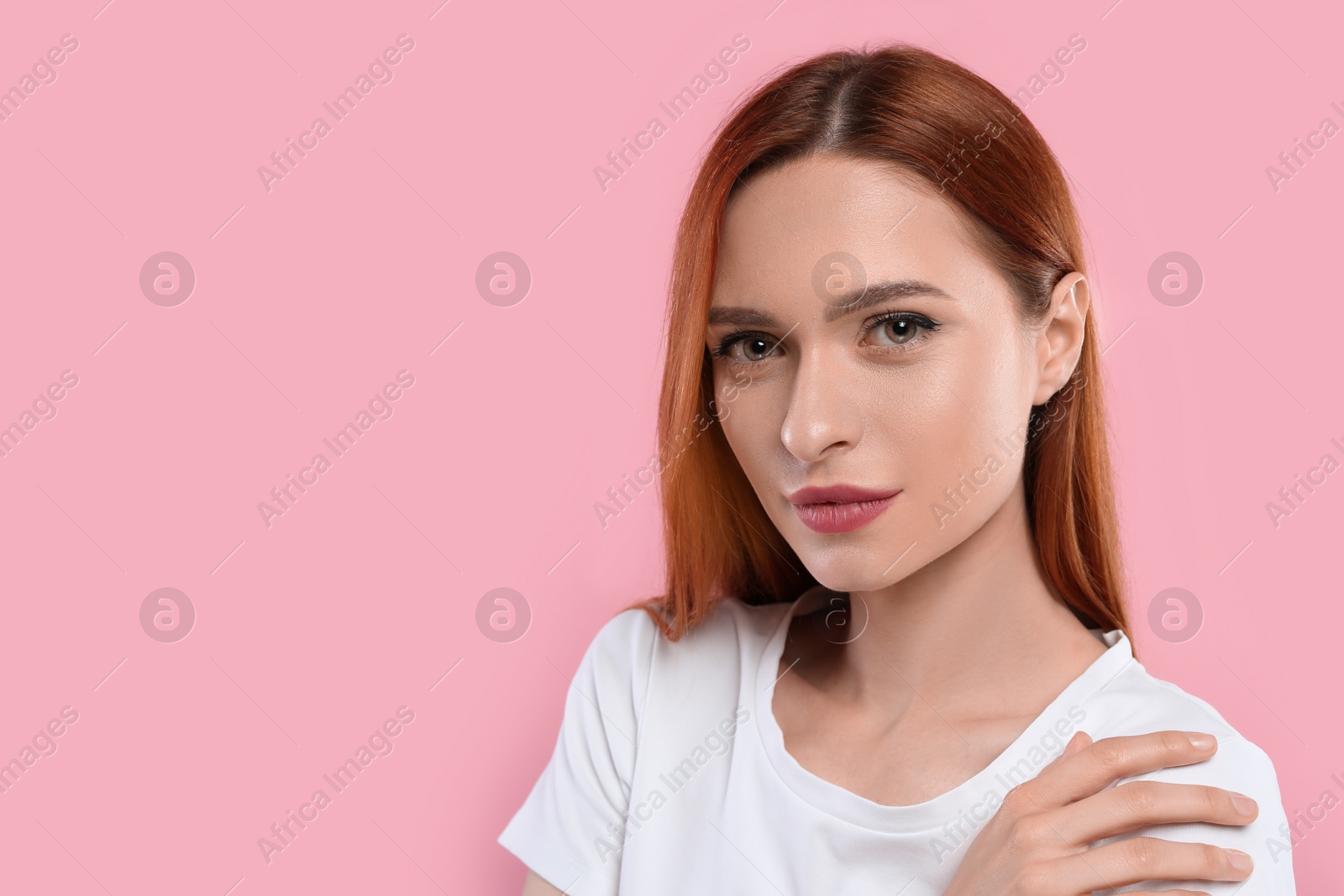 Photo of Portrait of beautiful young woman on pink background, space for text