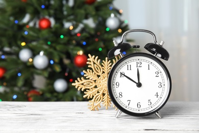 Photo of Retro alarm clock and festive decor on table. Christmas countdown