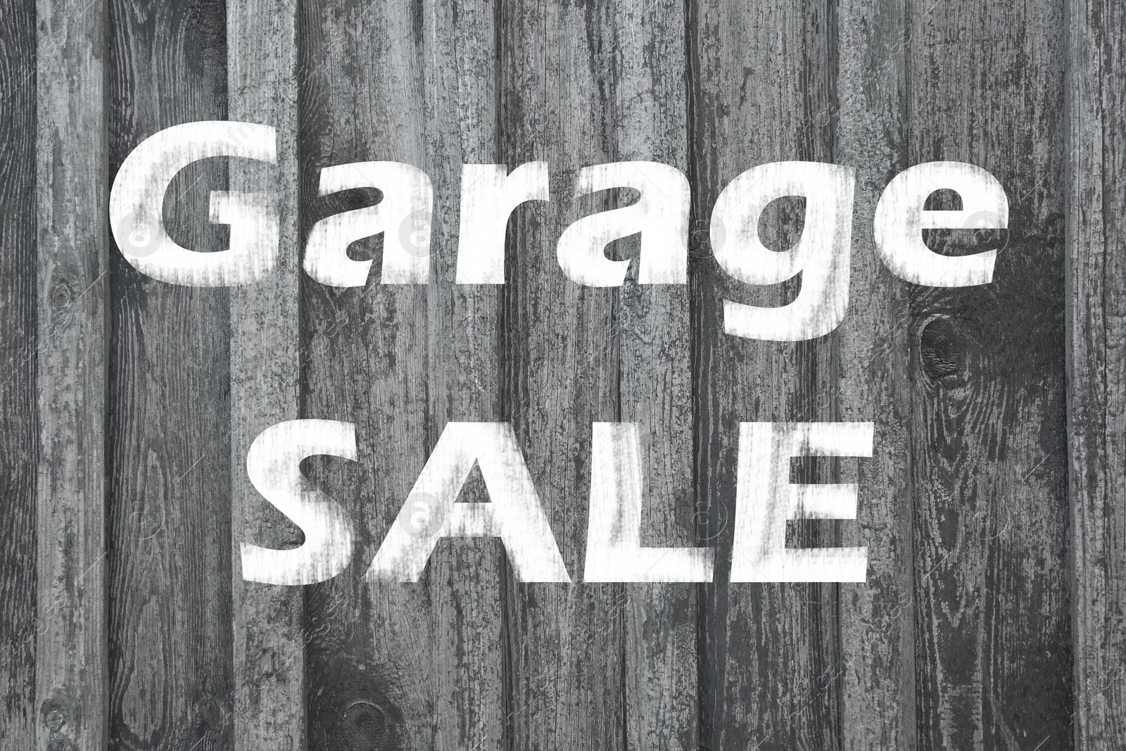 Image of Phrase GARAGE SALE written on wooden surface 