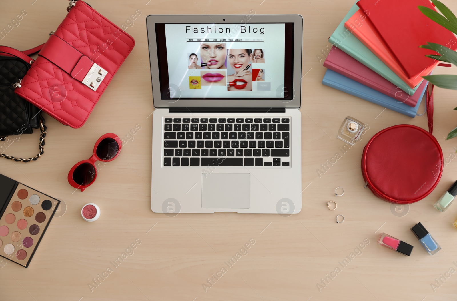 Photo of Laptop with open fashion blogger site on table, top view