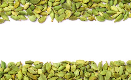 Dry green cardamom pods on white background, flat lay. Space for text