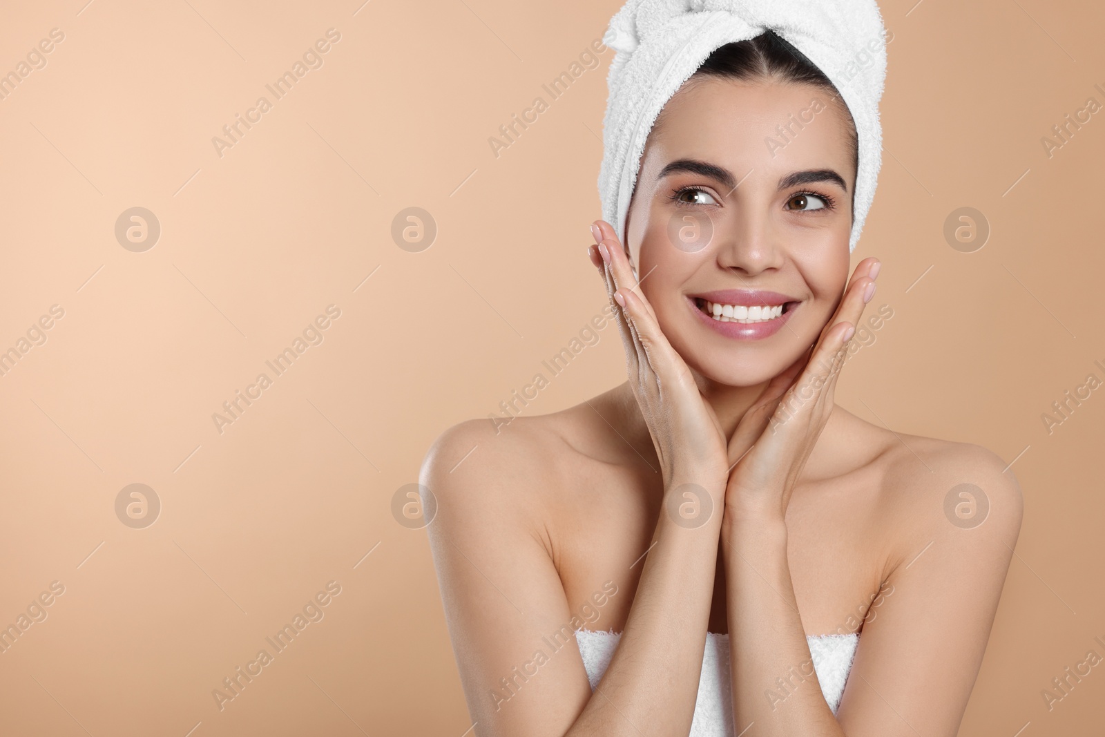Photo of Young woman in towels on beige background, space for text. Spa treatment