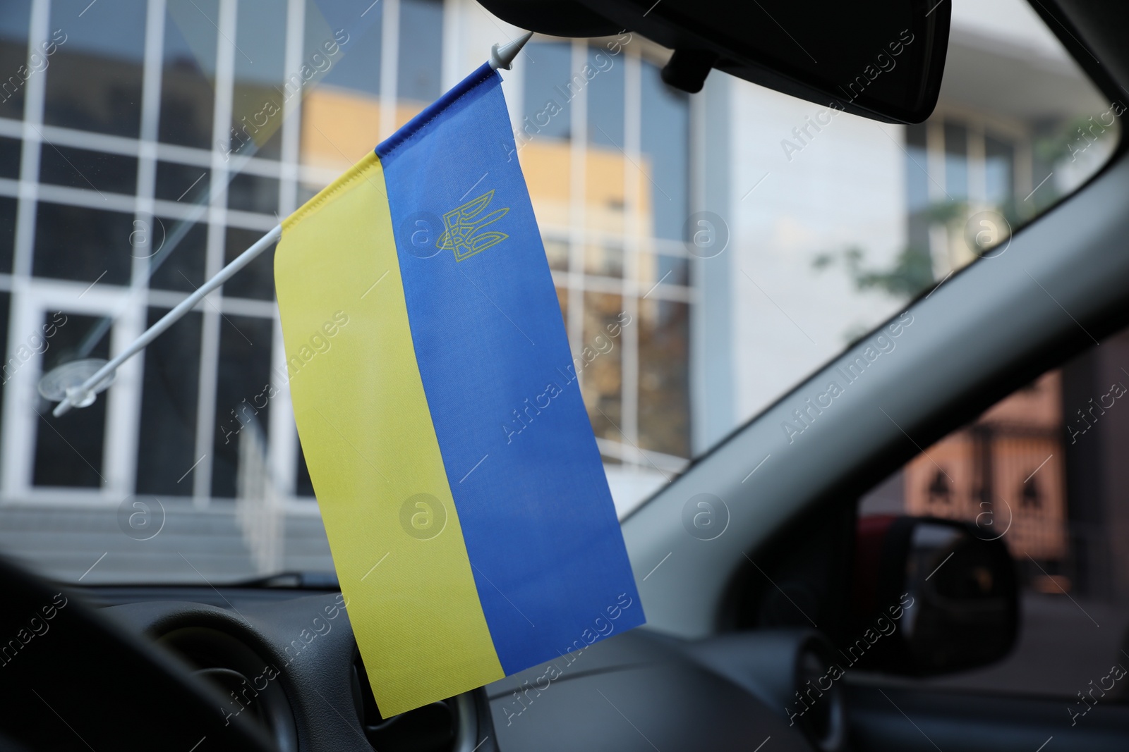 Photo of National flag of Ukraine on windshield inside car