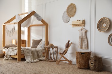 Stylish child room interior with house bed