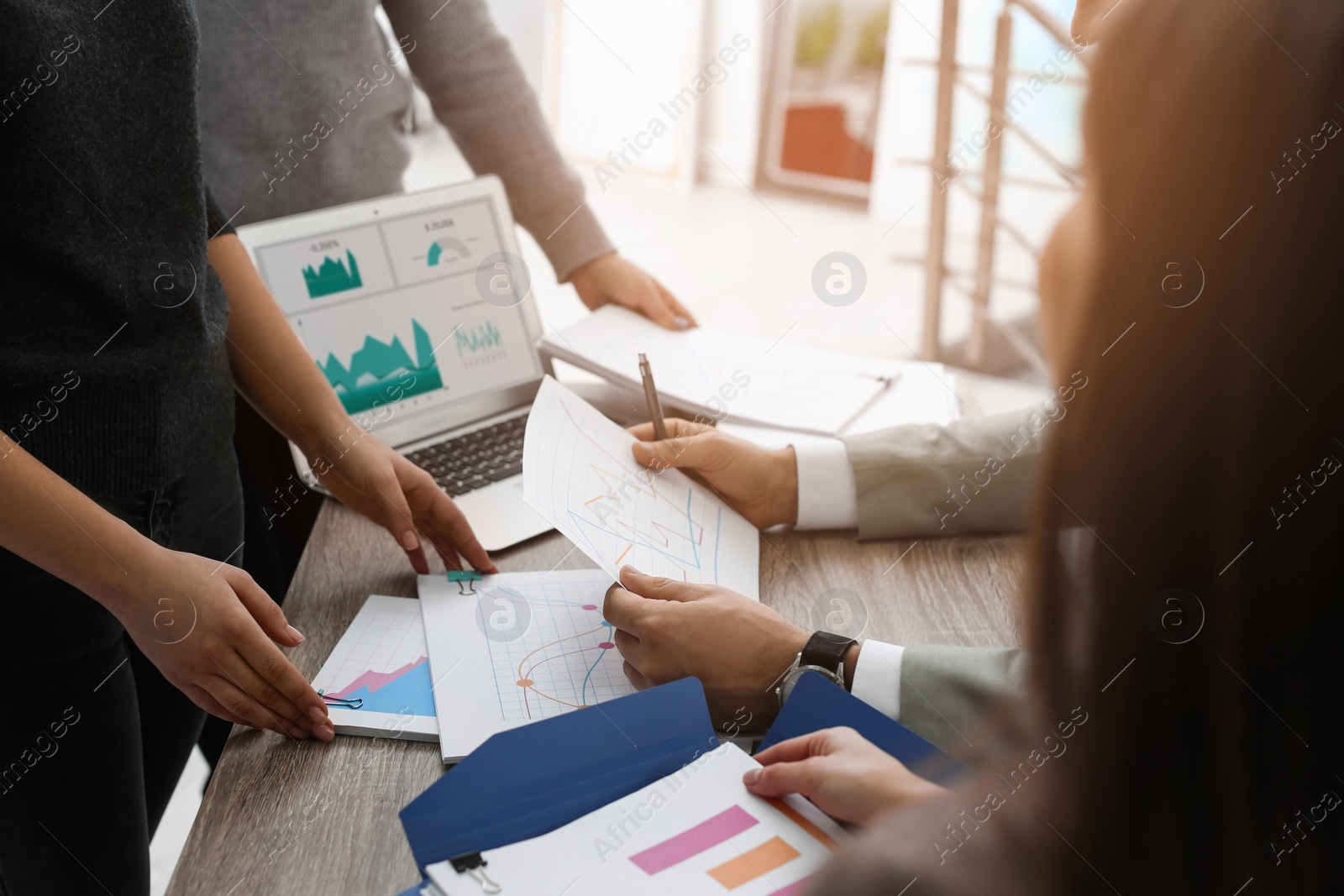 Image of Office employees working with documents at table, closeup. Business analytics