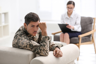 Photo of Male military officer having appointment with psychotherapist in office