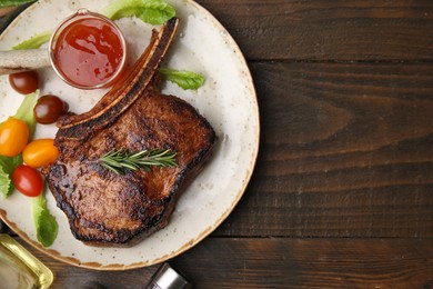 Photo of Tasty grilled meat, rosemary, tomatoes and marinade on wooden table, top view. Space for text