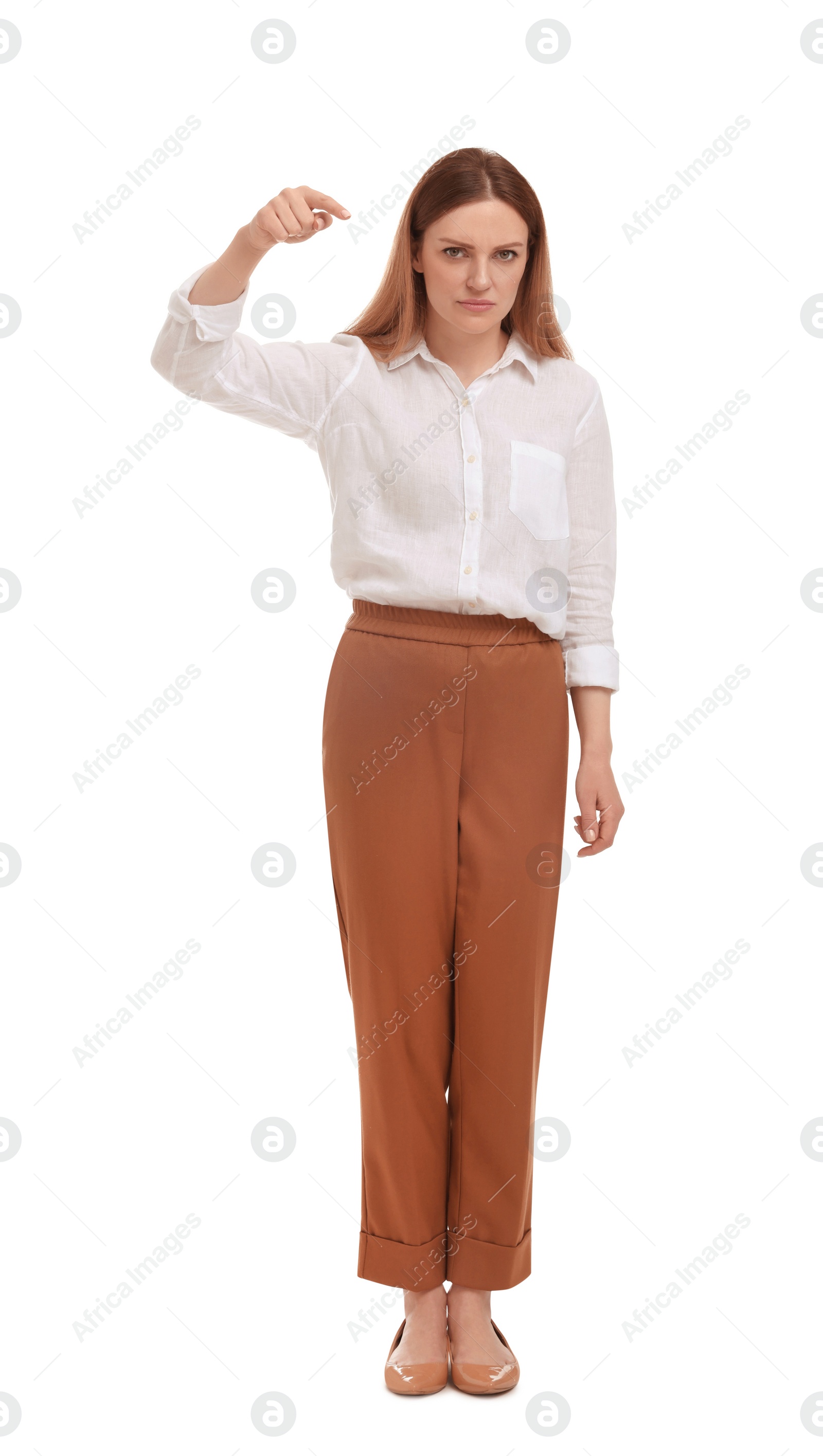 Photo of Beautiful businesswoman pointing at something on white background