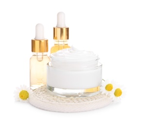 Photo of Chamomile flowers and cosmetic products on white background