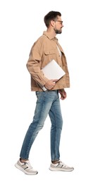 Man with laptop walking on white background