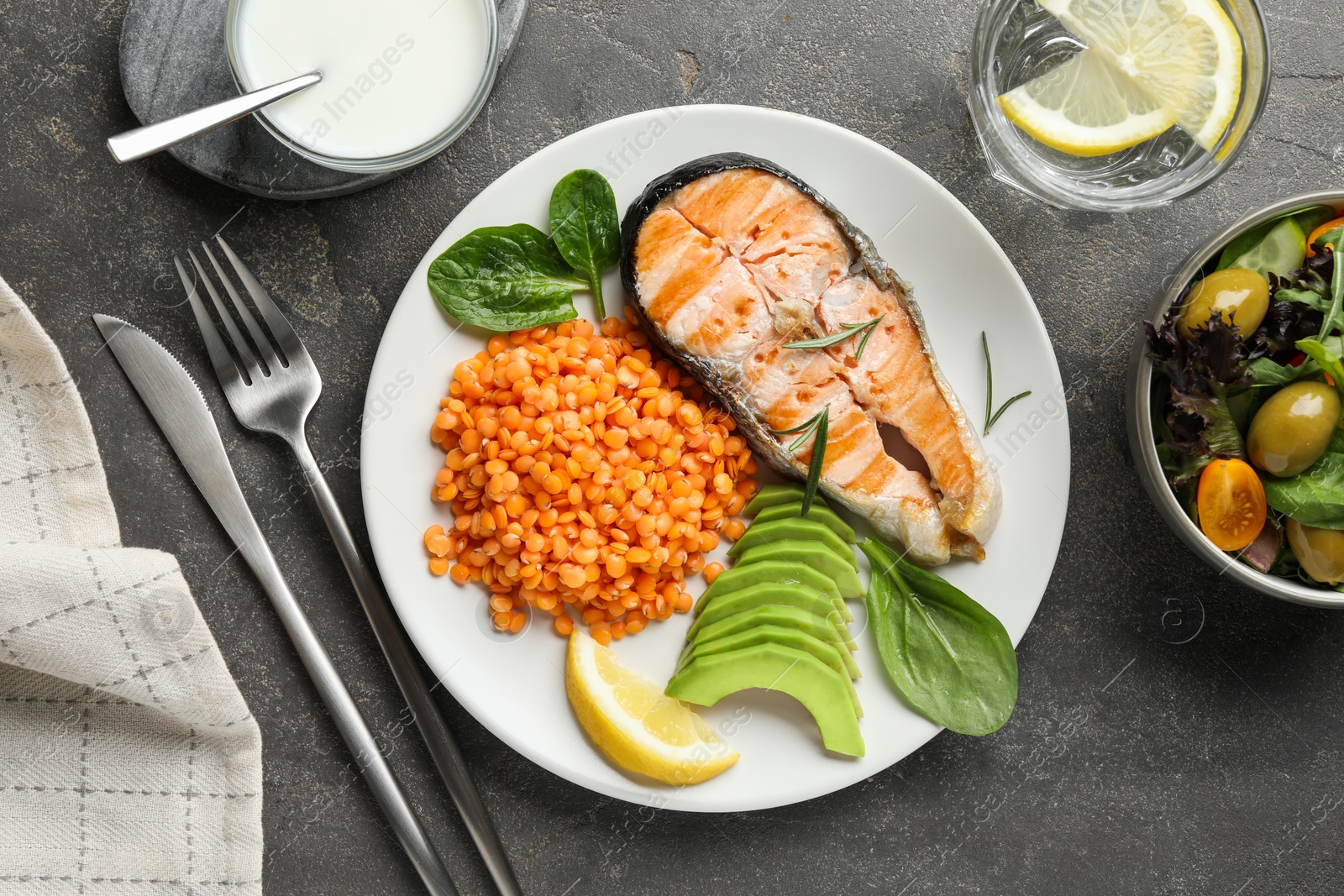 Photo of Healthy food high in vegetable fats served on grey textured table, flat lay