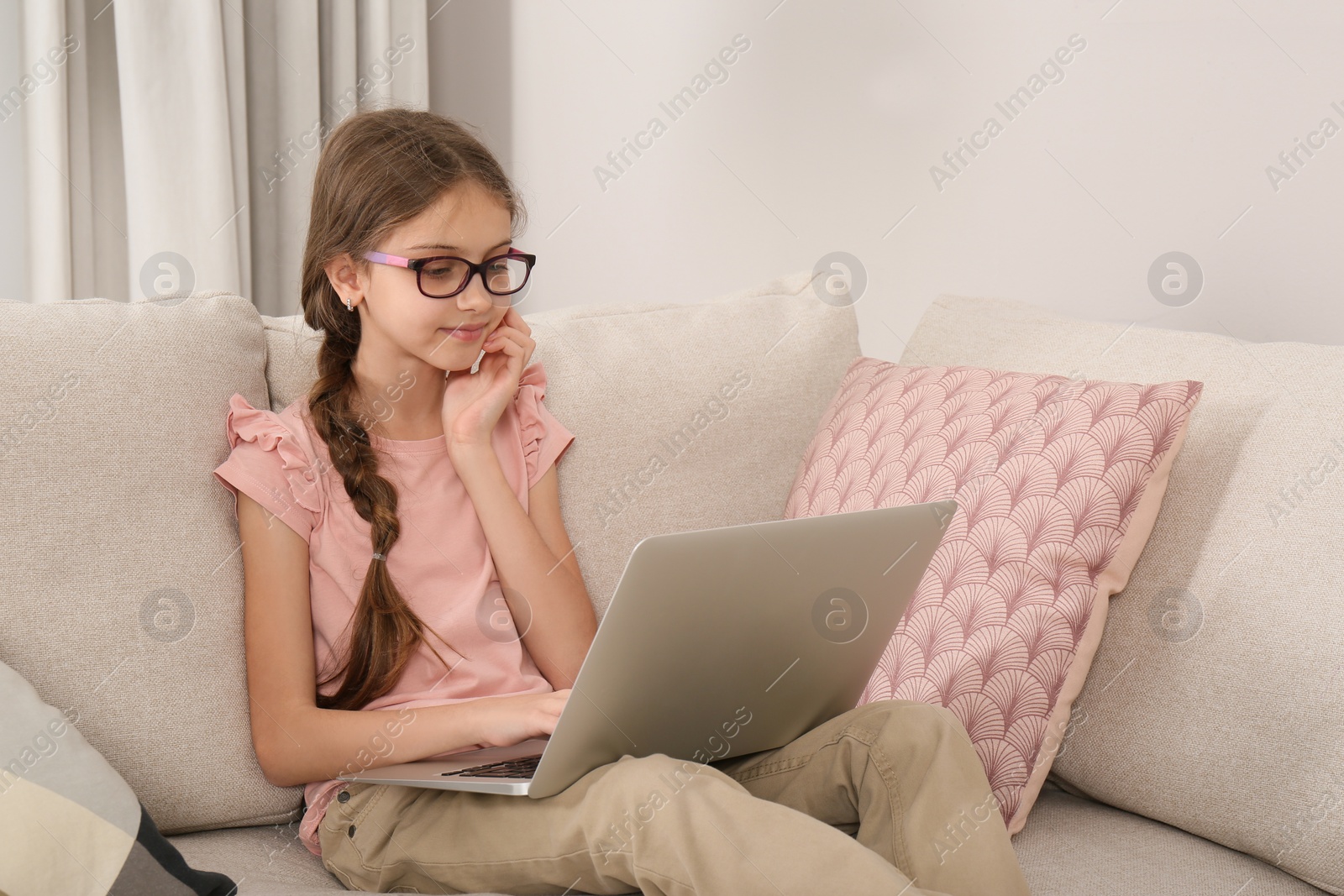 Photo of Girl with laptop on sofa at home