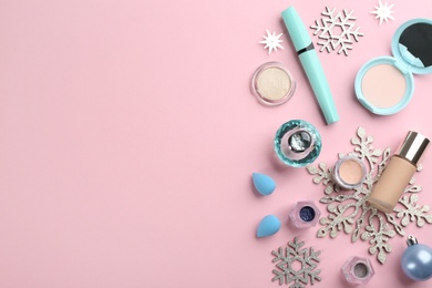 Photo of Flat lay composition with decorative cosmetic products on pink background, space for text. Winter care