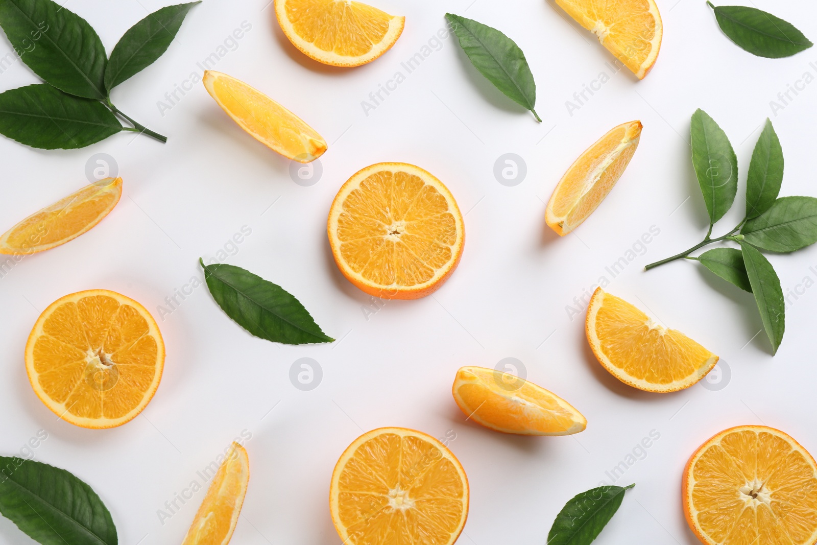 Photo of Slices of delicious oranges on white background, flat lay