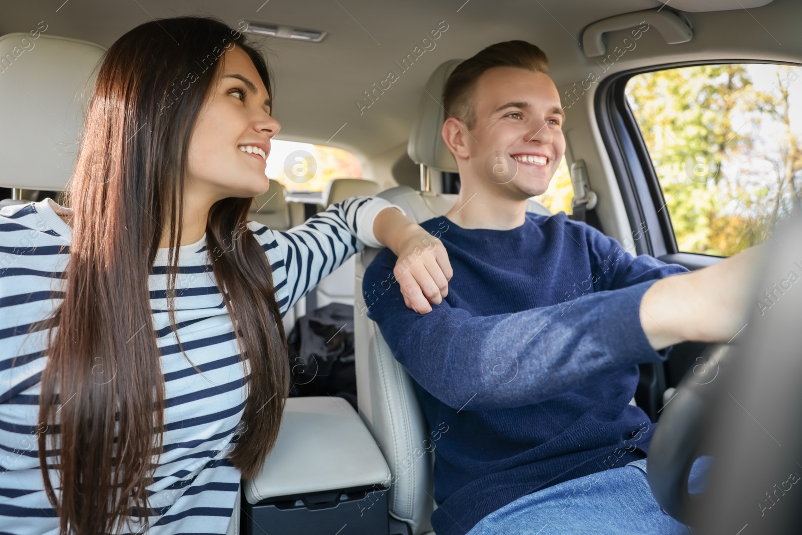 Photo of Happy young couple travelling together by car