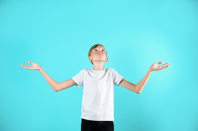 Photo of Portrait of young boy standing against color background